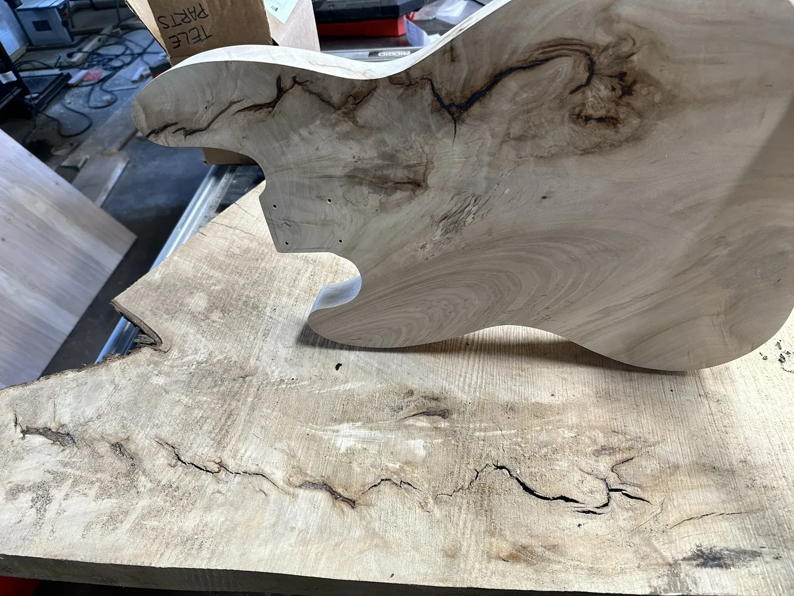 Close-up of a guitar body crack with copper shielding foil