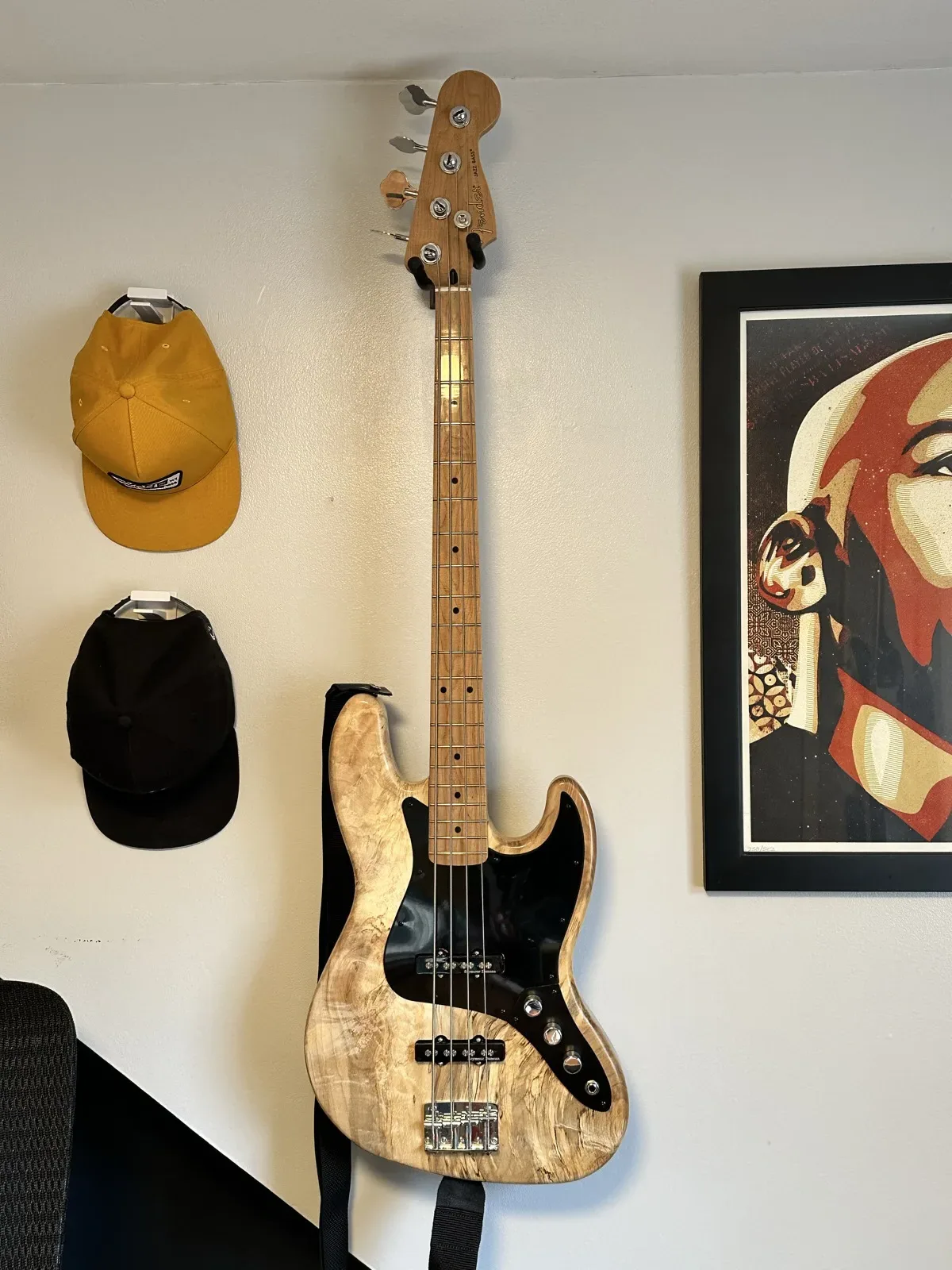 Finished spalted maple Jazz Bass hanging on a wall