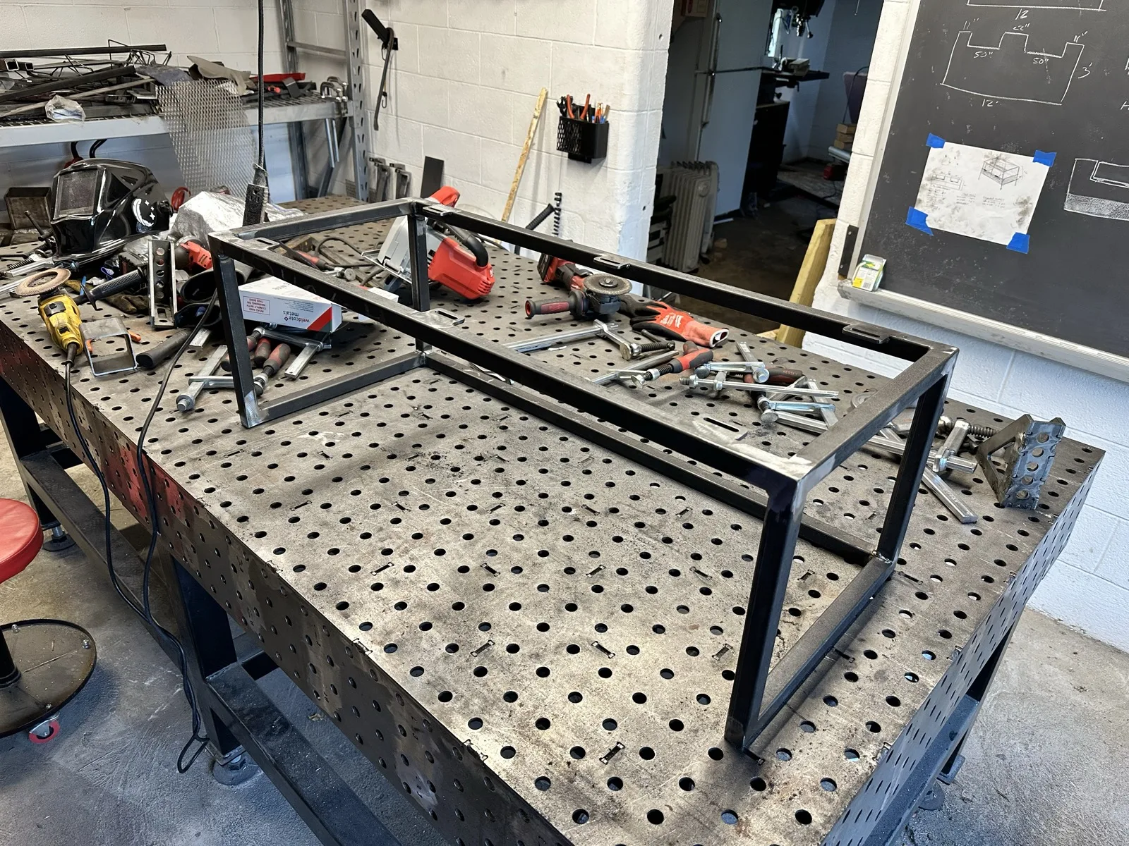 Welded steel table frame in progress on a fabrication table