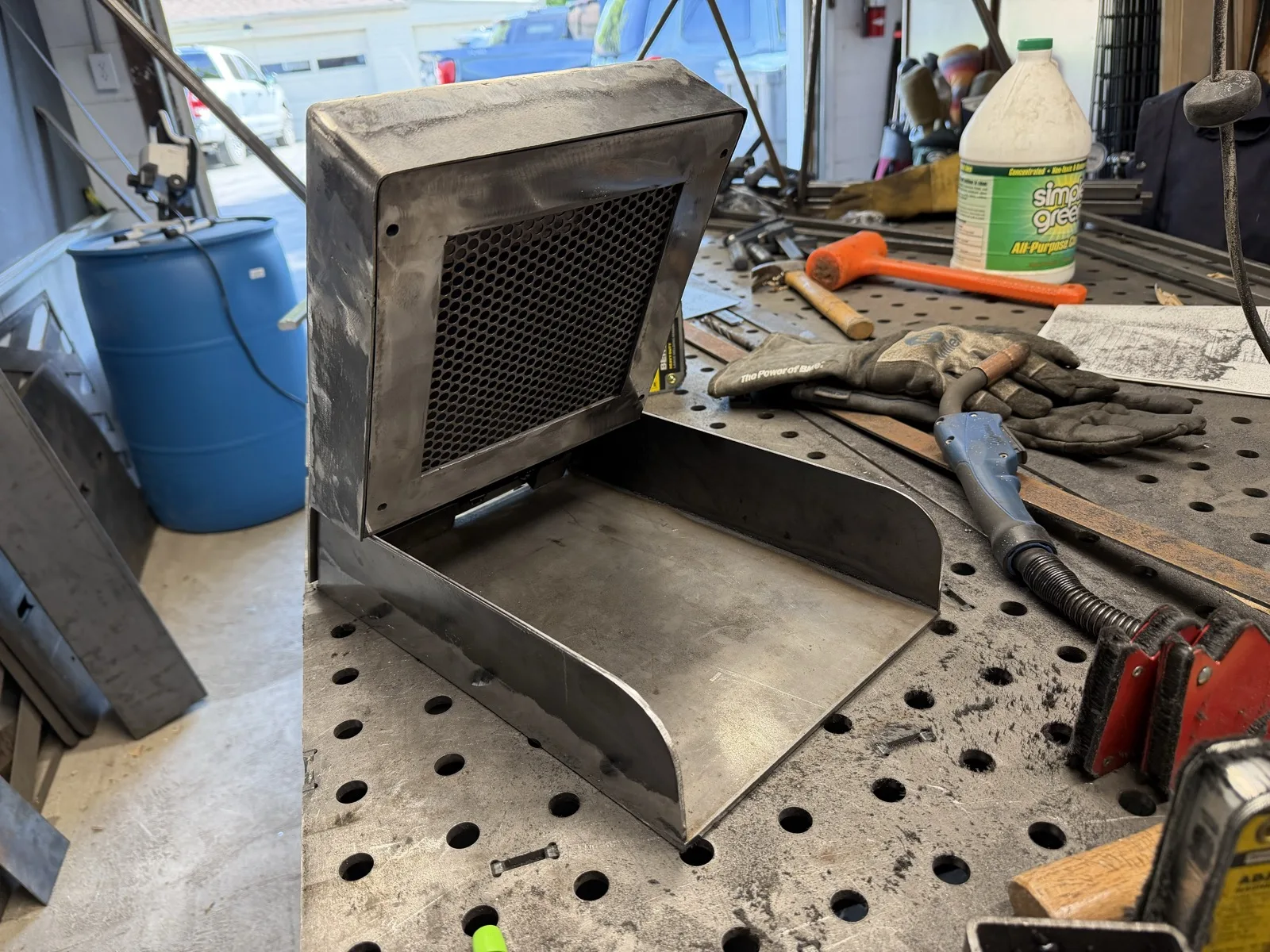 Welded steel vent hood enclosure with a mesh grille