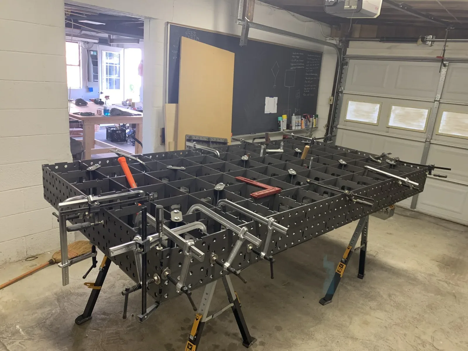Overhead view of a modular welding table in a garage