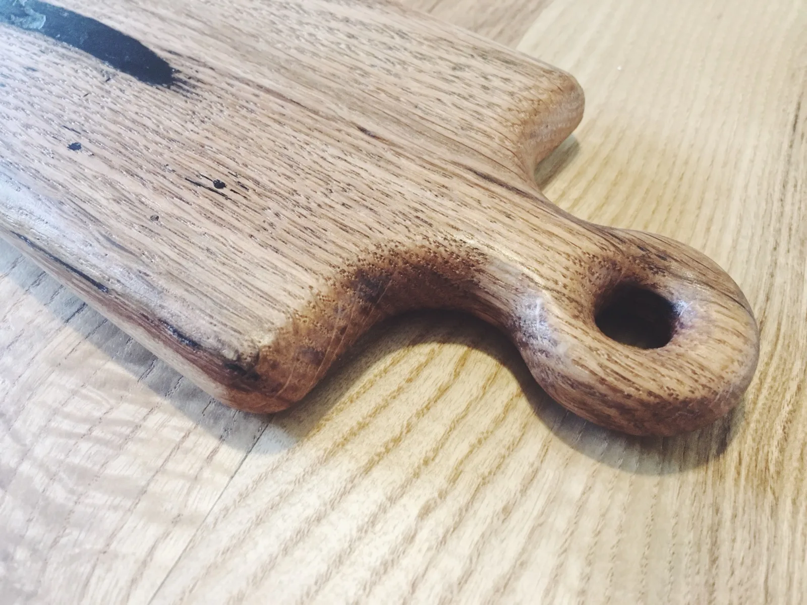Close-up of a wooden serving board handle
