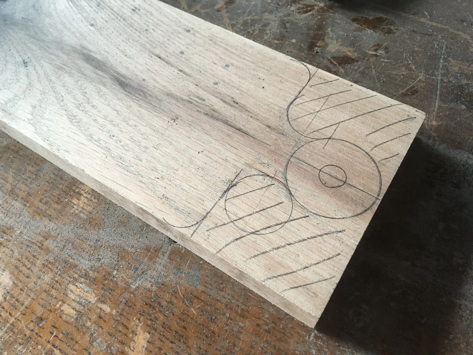 Pencil layout marks on a board before cutting