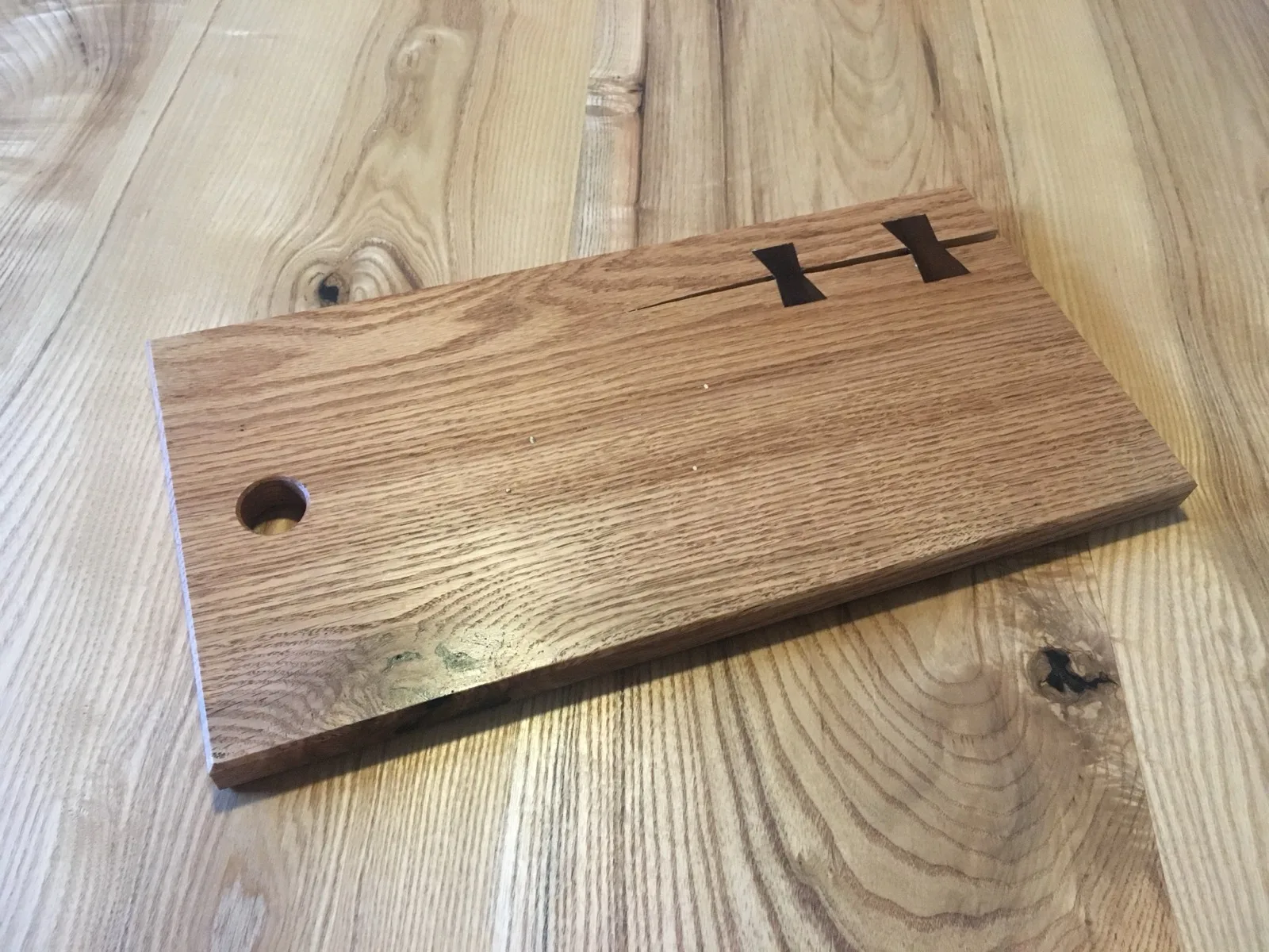End-grain cutting board with a butterfly key inlay