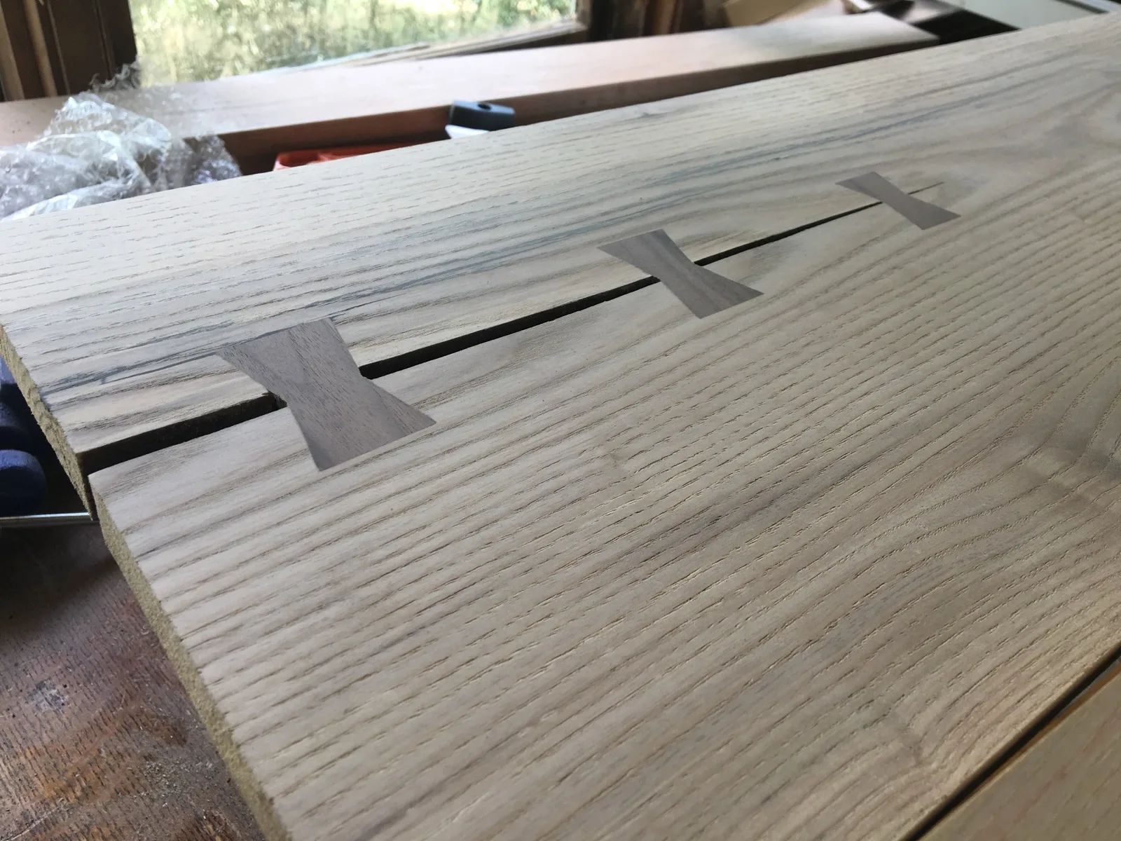 Butterfly key inlays repairing a crack in a board