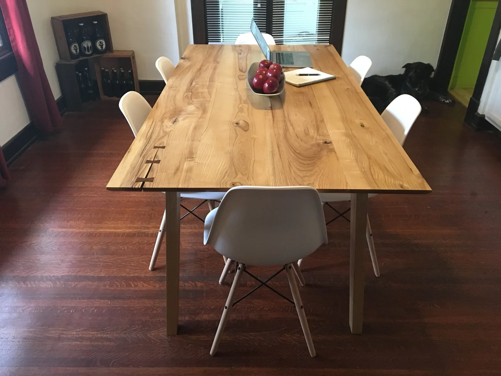 Finished live-edge dining table with chairs and a dog