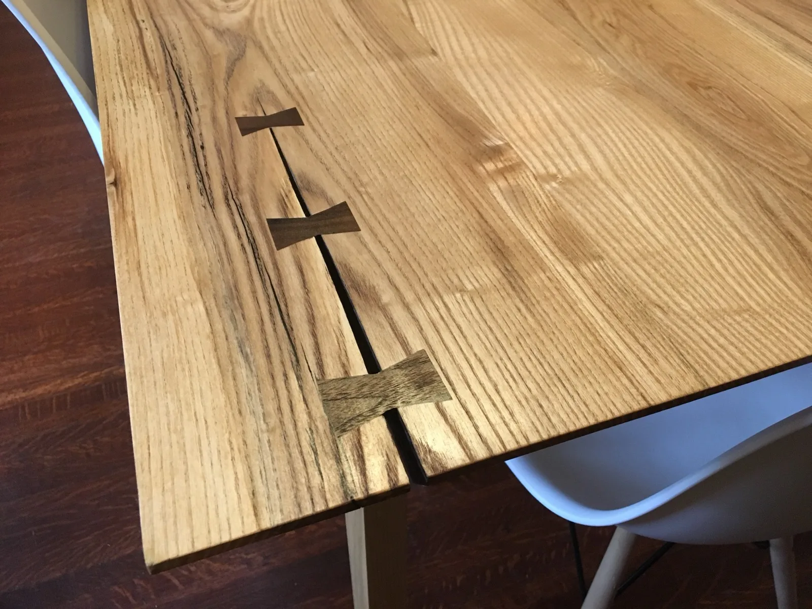 Close-up of butterfly key inlays on a live-edge dining table