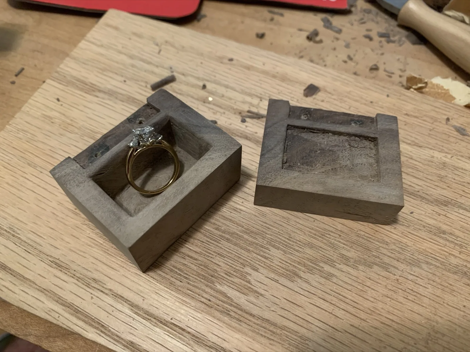 Wooden ring box with an engagement ring inside