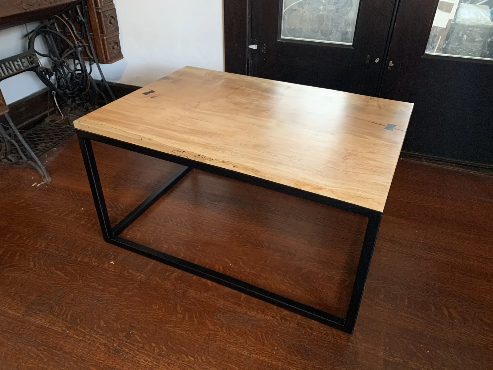 Live-edge wood shelf mounted on black brackets