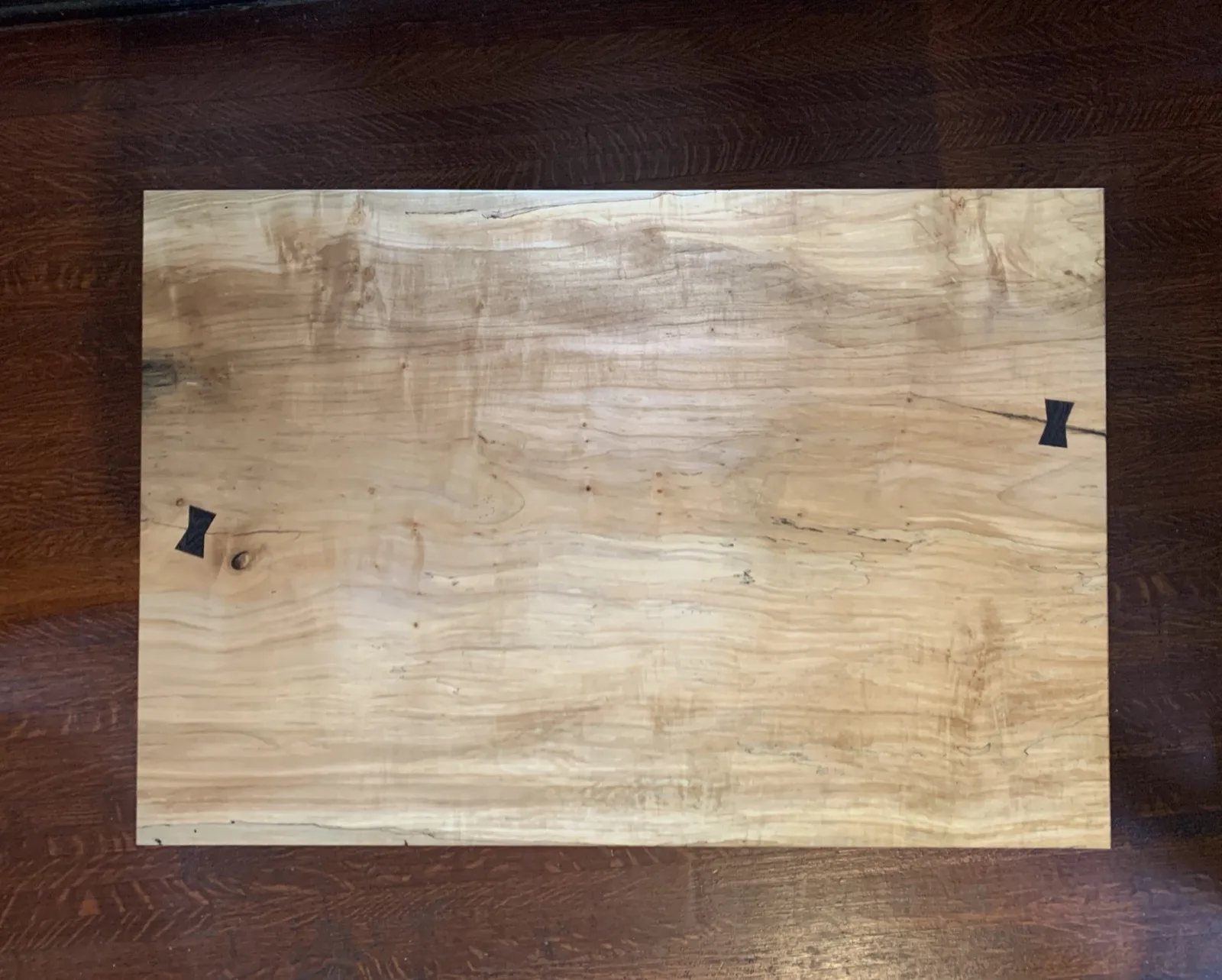 Wood tabletop panel with two butterfly key inlays
