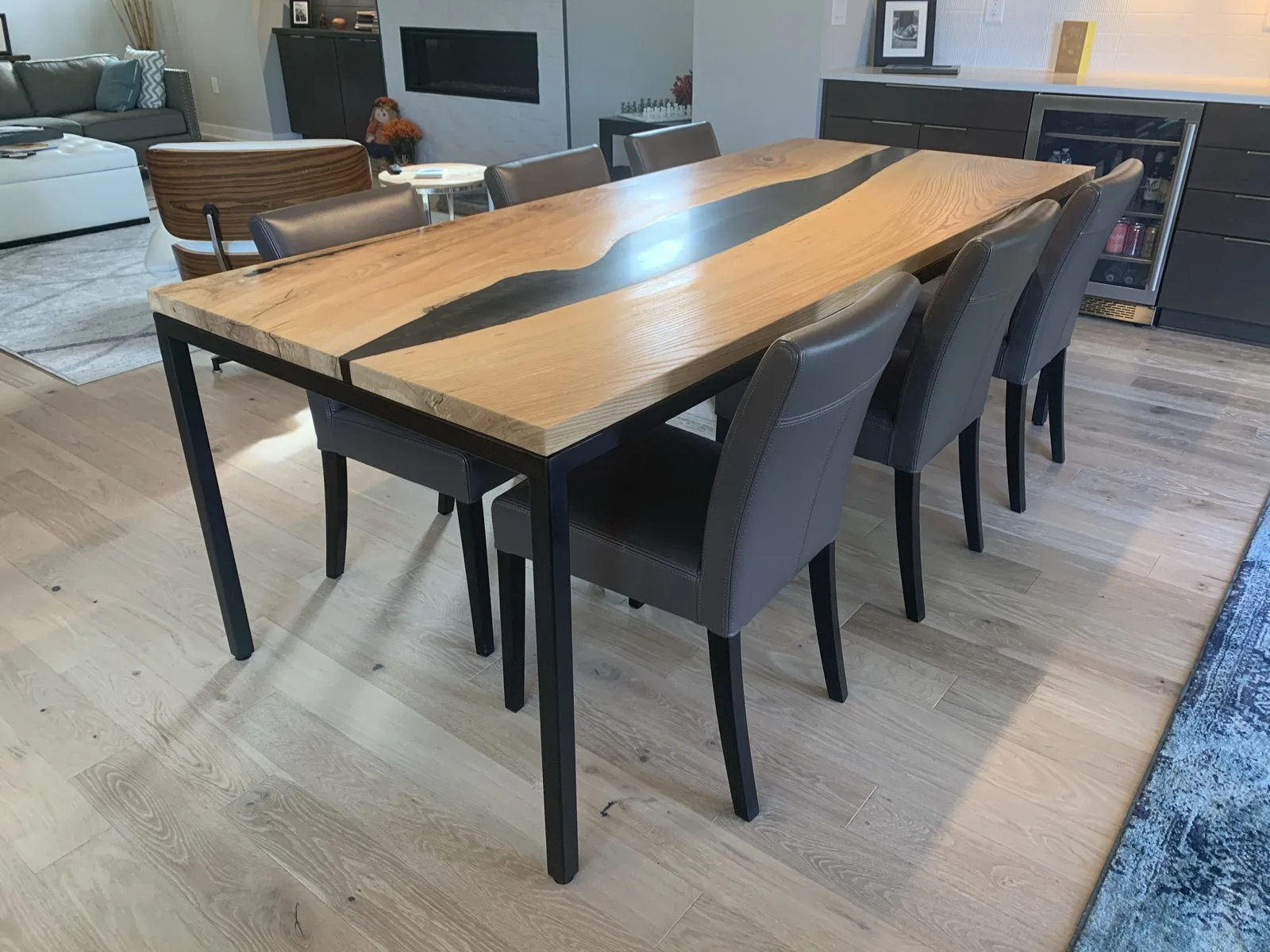 Finished epoxy river dining table in a modern living room