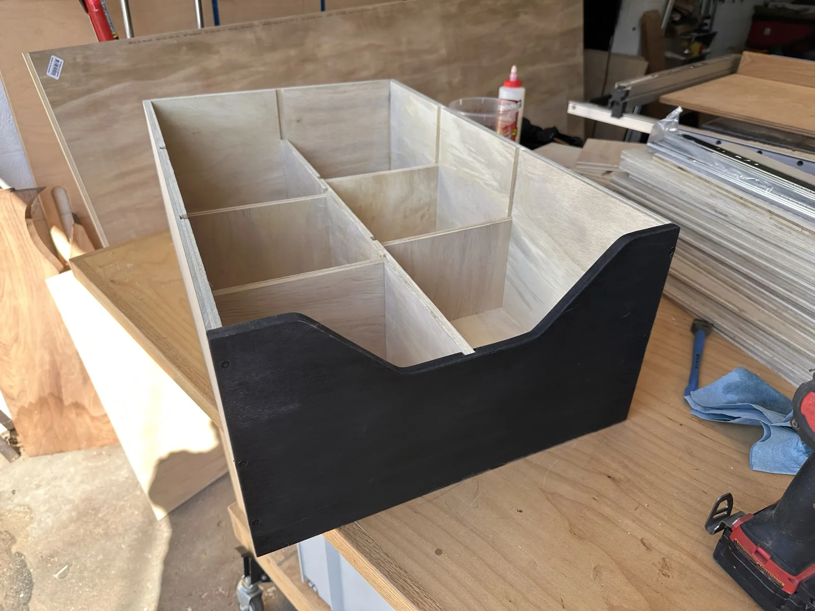 Divided wooden organizer caddy with a black-painted front